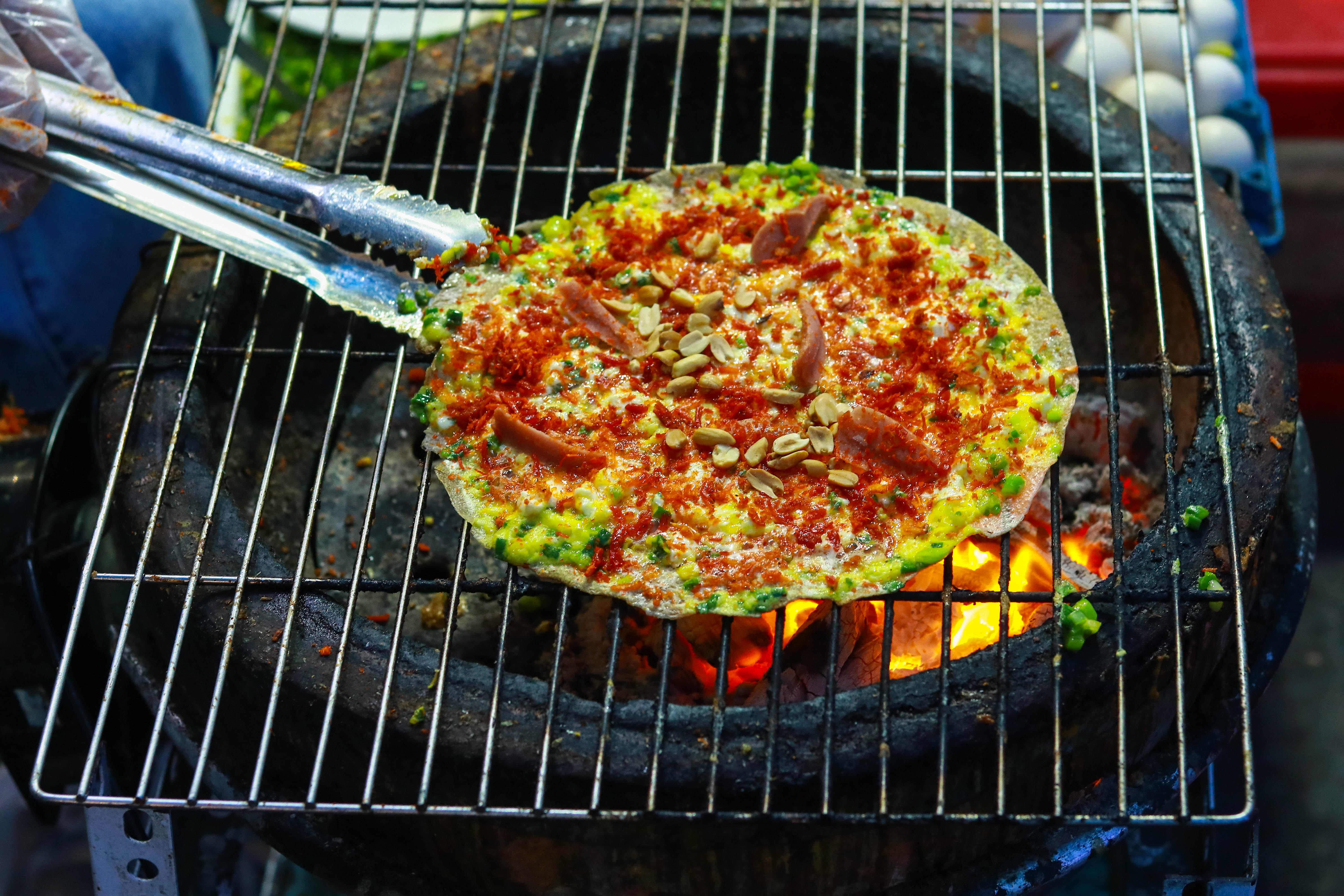Uncover Vietnamese street food culture with Vietnamese pizza Banh Trang Nuong